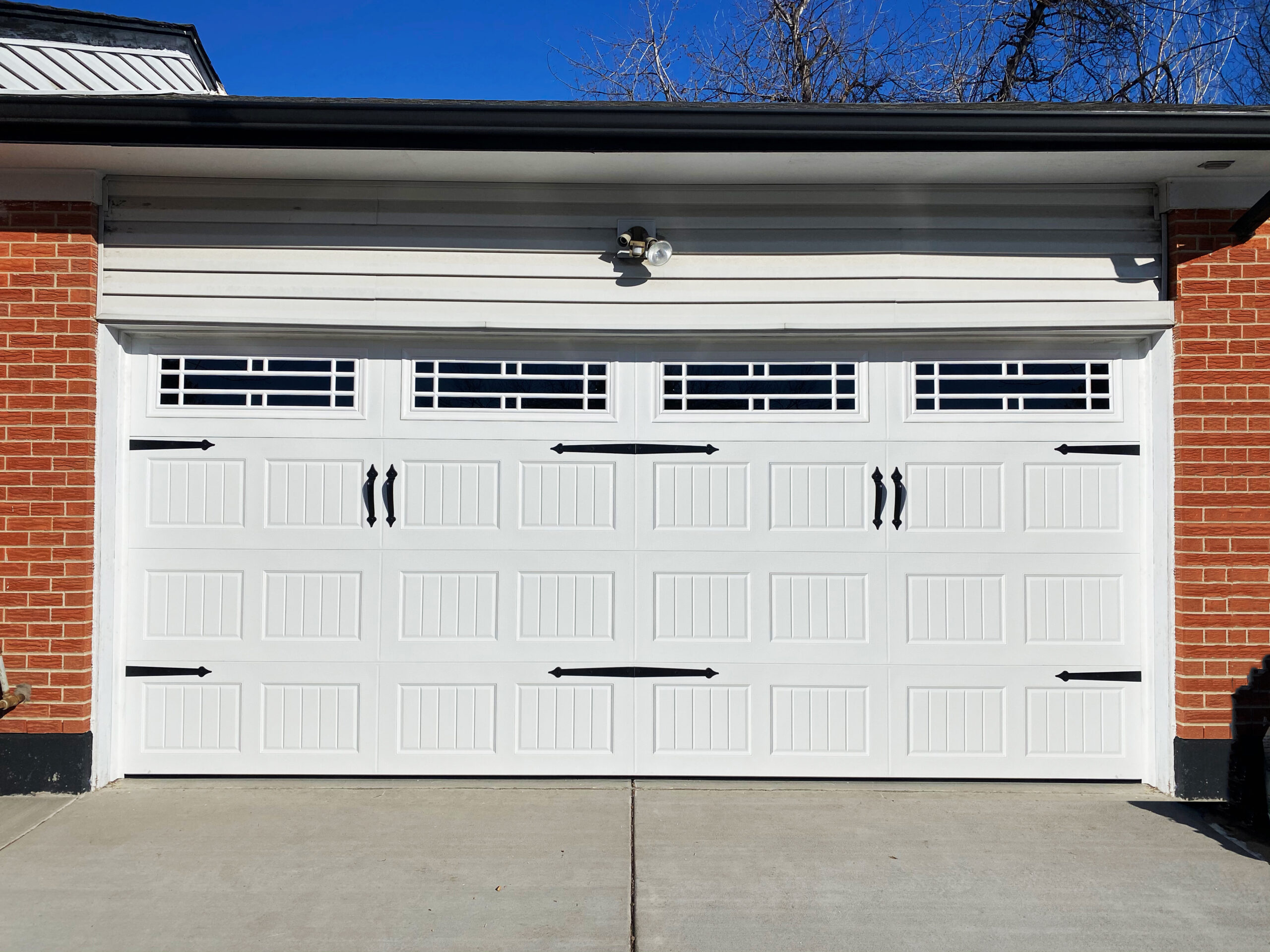 A garage door makeover complete with magnetic carriage hardware