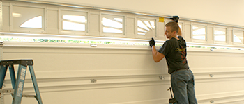 photo installing garage door section with windows